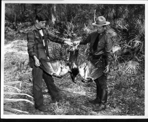 Photo Dr. Mount with a game warden and a golden eagle.